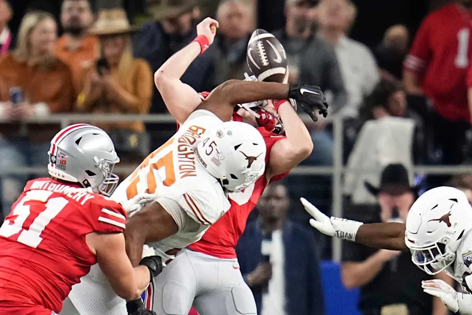 Texas Longhorns defensive lineman Vernon Broughton (45) hits Ohio State Buckeyes quarterback Will Howard (18) during the Cotton Bowl Classic College Football Playoff semifinal. © Adam Cairns/Columbus Dispatch / USA TODAY NETWORK via Imagn Images