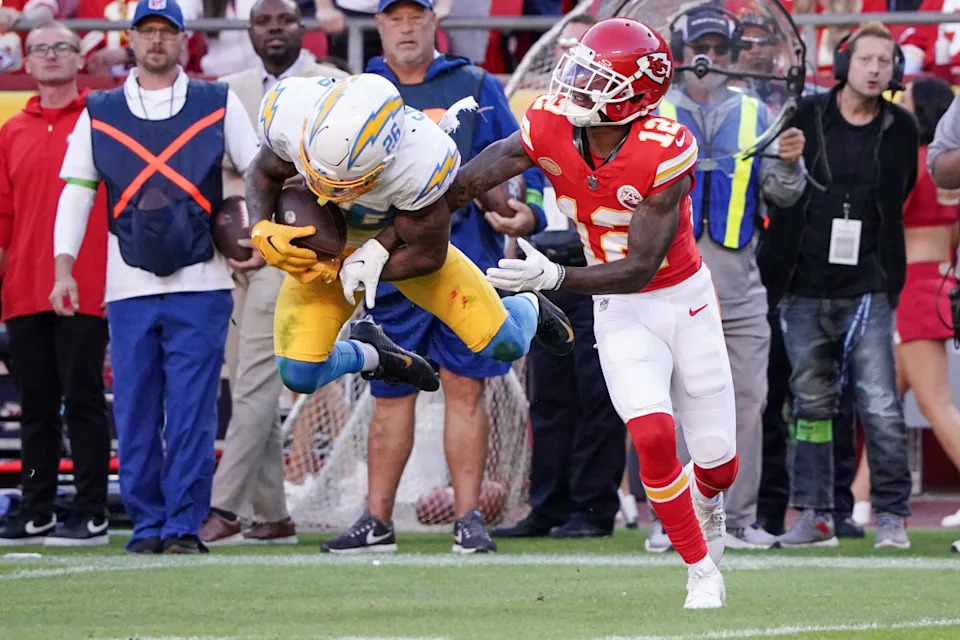 Los Angeles Chargers cornerback Asante Samuel Jr. (26) intercepts a pass intended for Kansas City Chiefs wide receiver Mecole Hardman Jr. (12) during the first half at GEHA Field at Arrowhead Stadium.Denny Medley-Imagn Images