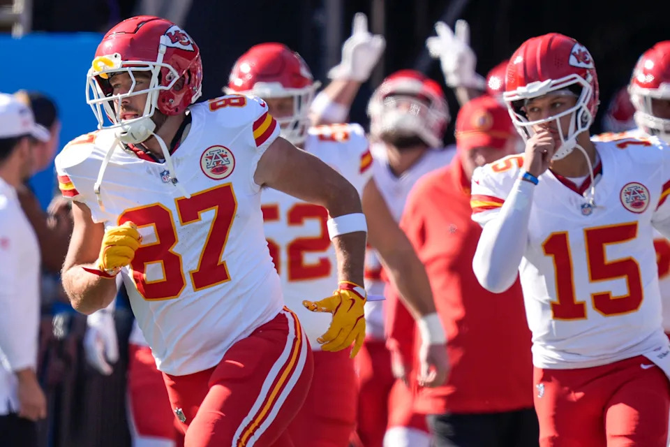 Nov 24, 2024; Charlotte, North Carolina, USA; Kansas City Chiefs tight end Travis Kelce (87) and quarterback Patrick Mahomes (15) lead their team onto the field against the Carolina Panthers during the first quarter at Bank of America Stadium. Mandatory Credit: Jim Dedmon-Imagn Images