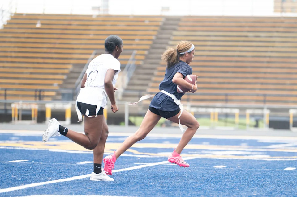 Battle Creek Central's Nae'ary Wilson and Jayne Bradley run a drill during a flag football practice at Battle Creek Central High School on Thursday, May 15, 2025.