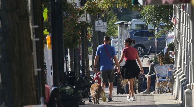 People walk through downtown Arlington Heights on Sept. 29, 2021.
