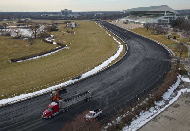 The synthetic racing surface is being removed from the track...