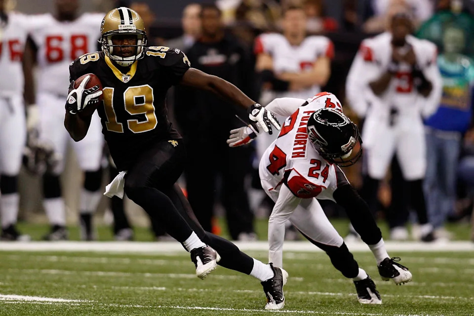 NEW ORLEANS - DECEMBER 07: Devery Henderson #19 of the New Orleans Saints avoids a tackle by Domonique Foxworth #24 of the Atlanta Falcons on his way to a 36 yard gain on December 7, 2008 at the Superdome in New Orleans, Louisiana. The Saints defeated the Falcons 29-25. (Photo by Chris Graythen/Getty Images)