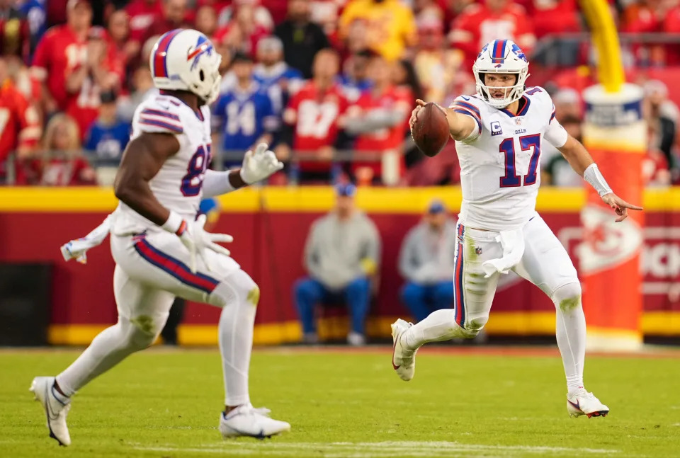 Oct 16, 2022; Kansas City, Missouri, USA; Buffalo Bills quarterback Josh Allen (17) signals to tight end Quintin Morris (85) while running the ball during the second half against the Kansas City Chiefs at GEHA Field at Arrowhead Stadium. Mandatory Credit: Jay Biggerstaff-USA TODAY Sports