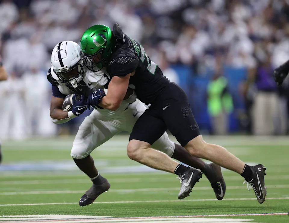 Dec 7, 2024; Indianapolis, IN, USA; Penn State Nittany Lions running back Nicholas Singleton (10) is tackled by Oregon Ducks linebacker Bryce Boettcher (28) during the second quarter in the 2024 Big Ten Championship game at Lucas Oil Stadium. Mandatory Credit: Jordan Prather-Imagn Images