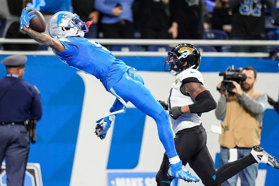 Detroit Lions wide receiver Jameson Williams (9) dives into the end zone to celebrate scoring a touchdown against Jacksonville Jaguars during the second half at Ford Field in Detroit on Sunday, Nov. 17, 2024.