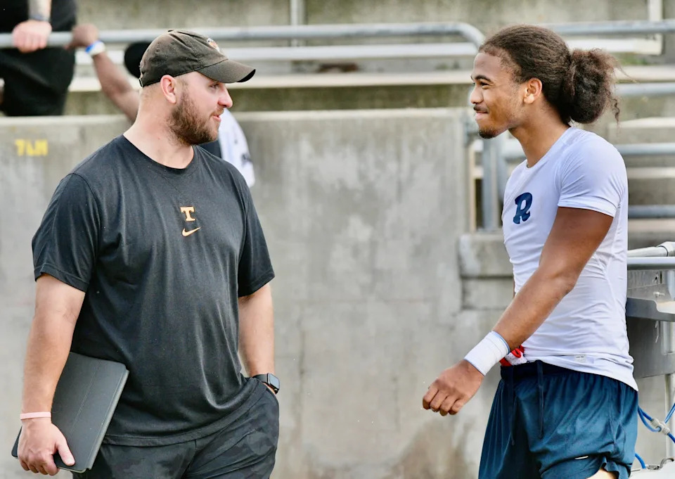 Redwood's Israel Briggs talks with a Tennessee recruiter on May 1, 2025 at the first annual Redwood College Showcase at Mineral King Bowl in Visalia.