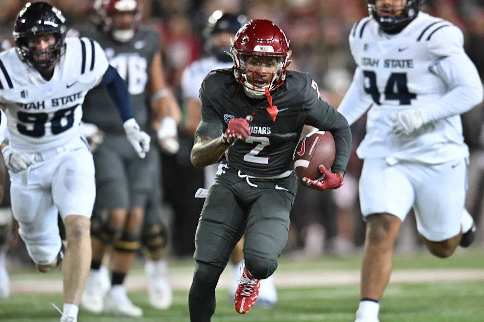 Nov 9, 2024; Pullman, Washington, USA; Washington State Cougars wide receiver Kyle Williams (2) runs the ball in for a touchdown against the Utah State Aggies in the first half at Gesa Field at Martin Stadium. Mandatory Credit: James Snook-Imagn Images