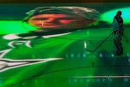 An image of Dallas Stars goaltender Jake Oettinger is projected on the ice over Winnipeg...