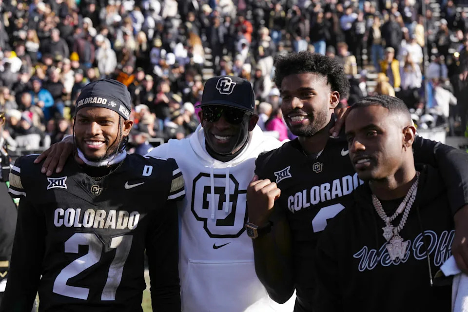 Colorado Buffaloes safety Shilo Sanders (21), head coach Deion Sanders, quarterback Shedeur Sanders (2) and Deion Sanders Jr.Ron Chenoy-Imagn Images