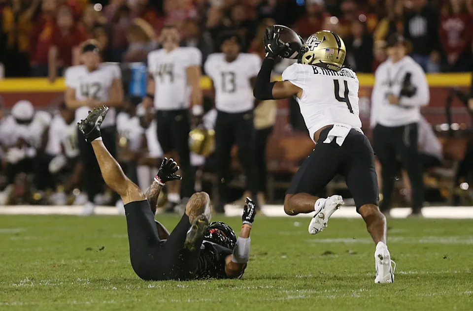 UCF Knights defensive back Braeden Marshall (4) catches the ball for an interception around Iowa State Cyclones wide receiver Jaylin Noel (13) during the fourth quarter in the week-8 NCAA football at Jack Trice Stadium on Saturday, Oct. 19, 2024, in Ames, Iowa.