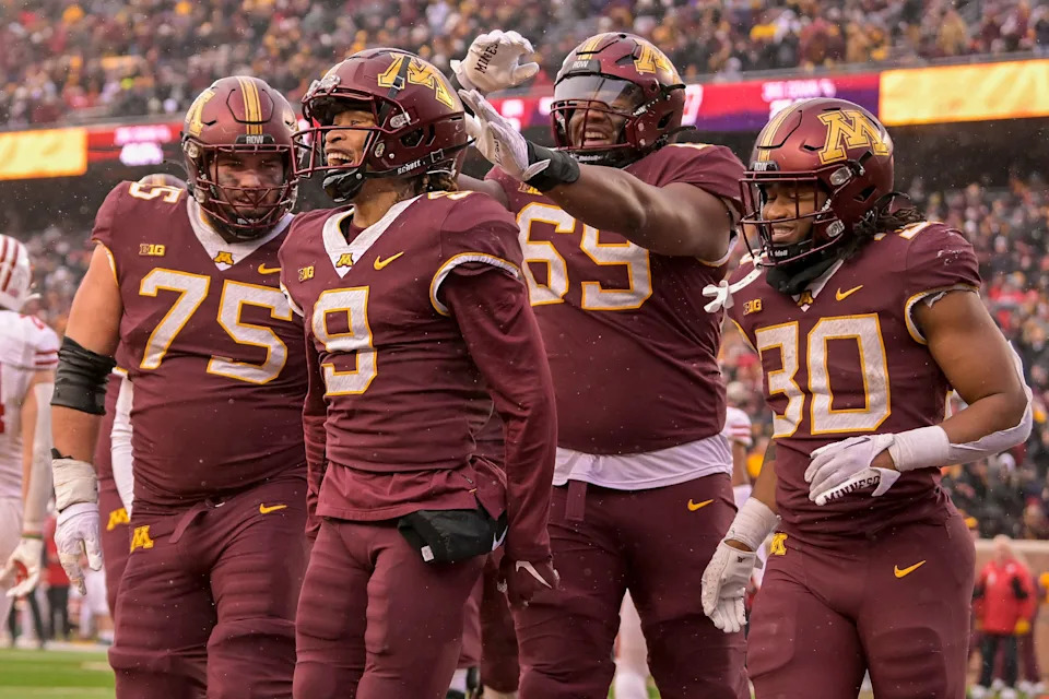 Nov 25, 2023; Minneapolis, Minnesota, USA; Minnesota Golden Gophers wide receiver Daniel Jackson (9) celebrates his 7-yard touchdown reception against the Wisconsin Badgers with offensive lineman Tyler Cooper (75), offensive lineman Aireontae Ersery (69), and running back Jordan Nubin (30) during the second quarter at Huntington Bank Stadium. Mandatory Credit: Nick Wosika-USA TODAY Sports