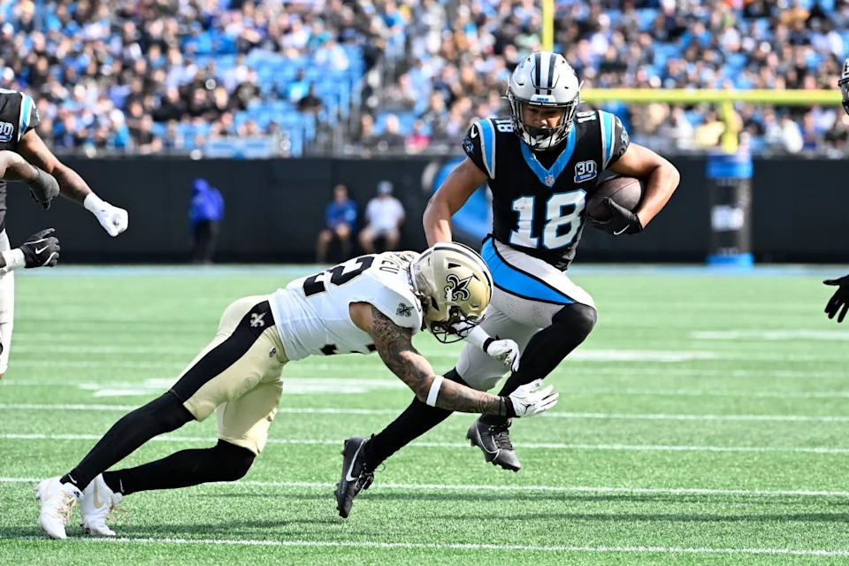 Carolina Panthers wide receiver Jalen Coker (18) with the ball as New Orleans Saints safety Tyrann Mathieu (32) defends in the second quarter at Bank of America Stadium.© Bob Donnan-Imagn Images