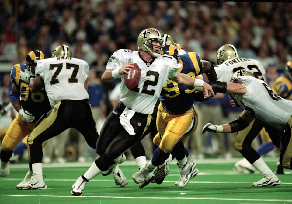 28 Nov 1999: Billy Joe Hobert #12 of the New Orleans Saints scrambles with the ball during a game against the St. Louis Rams at the Trans World Dome in St. Louis, Missouri. The Rams defeated the Saints 43-12. Mandatory Credit: Elsa Hasch /Allsport