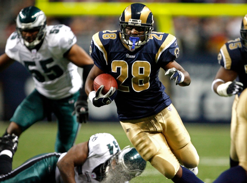 Rams running back Marshall Faulk (28) runs the ball in the second half during the St. Louis Rams loss 17-16 to the Philadelphia Eagles at Edward Jones Dome in St. Louis, MO. (Photo by Larry Smith /Icon SMI/Icon Sport Media via Getty Images)