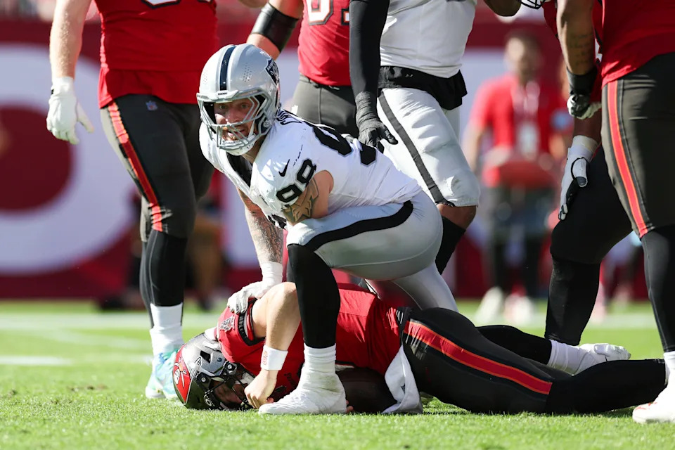 Dec 8, 2024; Tampa, Florida, USA; Las Vegas Raiders defensive end Maxx Crosby (98) sacks Tampa Bay Buccaneers quarterback Baker Mayfield (6) in the second quarter at Raymond James Stadium. Mandatory Credit: Nathan Ray Seebeck-Imagn Images