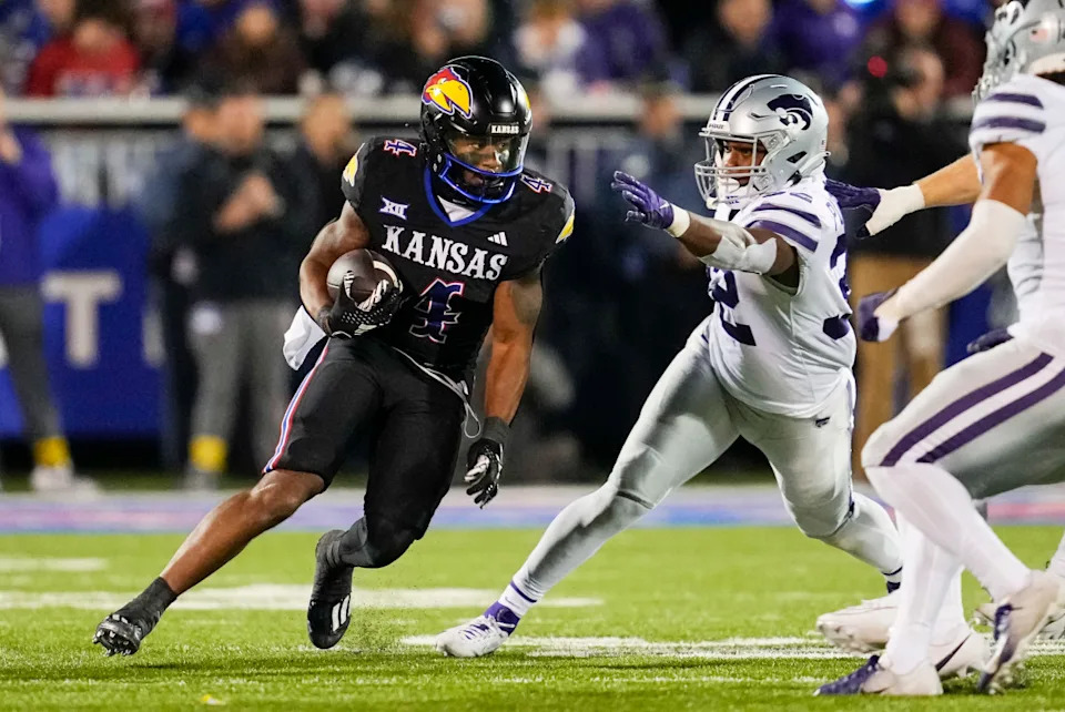 Kansas Jayhawks running back Devin Neal (4) runs the ball against the Kansas State Wildcats. Mandatory Credit: Jay Biggerstaff-Imagn Images