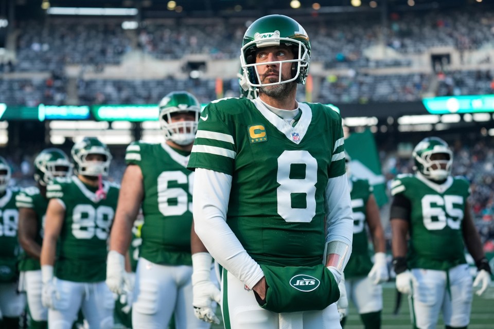 FILE - New York Jets quarterback Aaron Rodgers (8) stands with teammates before an NFL football game against the Miami Dolphins, Jan. 5, 2025, in East Rutherford, N.J. (AP Photo/Seth Wenig, File)