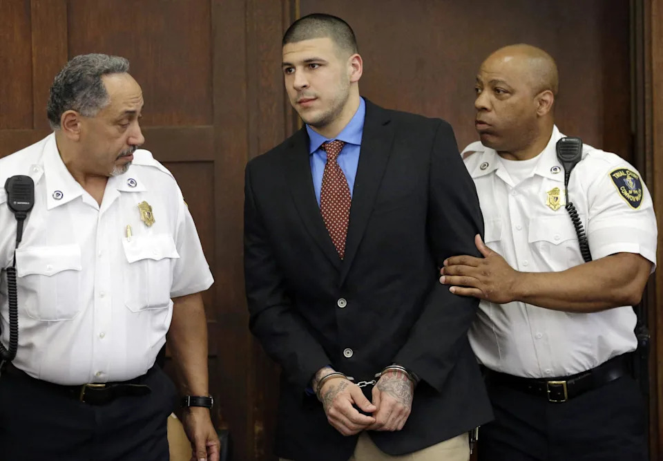 Aaron Hernandez in the court room in handcuffs.