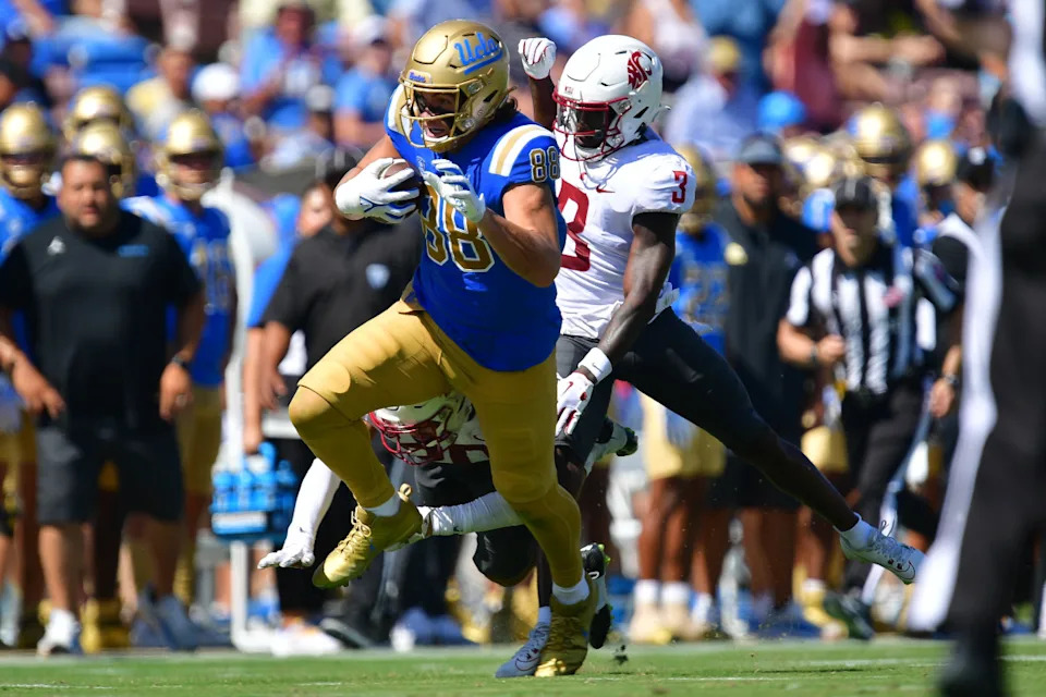 UCLA Bruins tight end Moliki Matavao (88) runs after a reception against the Washington State Cougars. Mandatory Credit: Gary A. Vasquez-Imagn Images