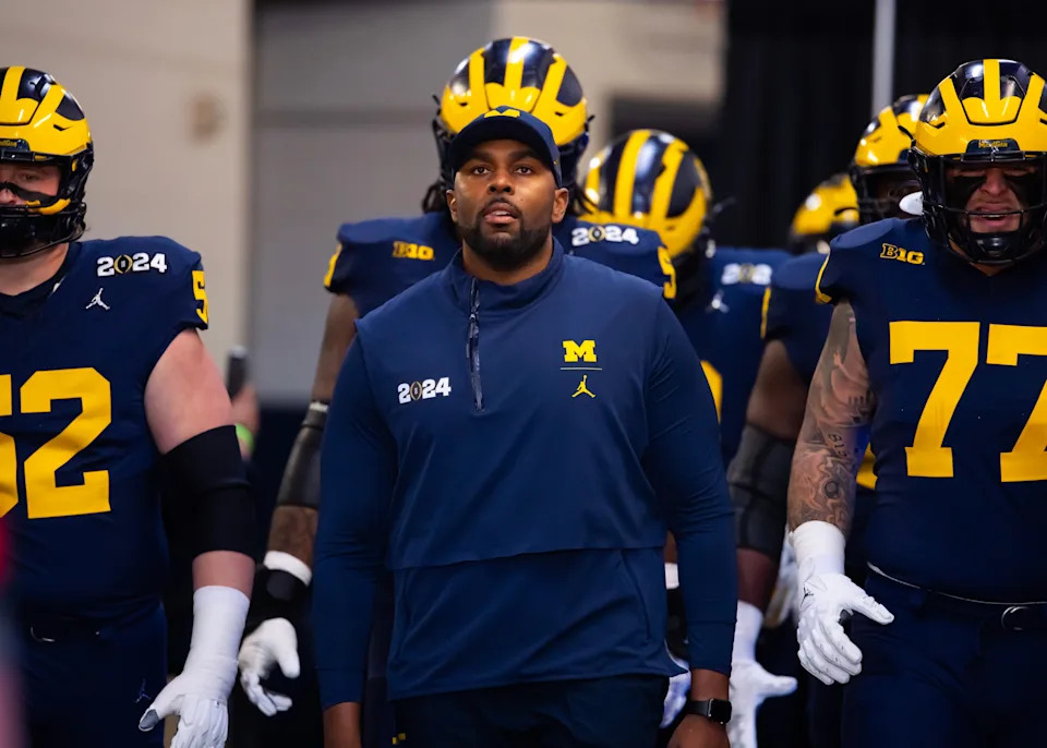 Michigan offensive coordinator Sherrone Moore walks to the field ahead of the College Football Playoff national championship game against Washington at NRG Stadium.