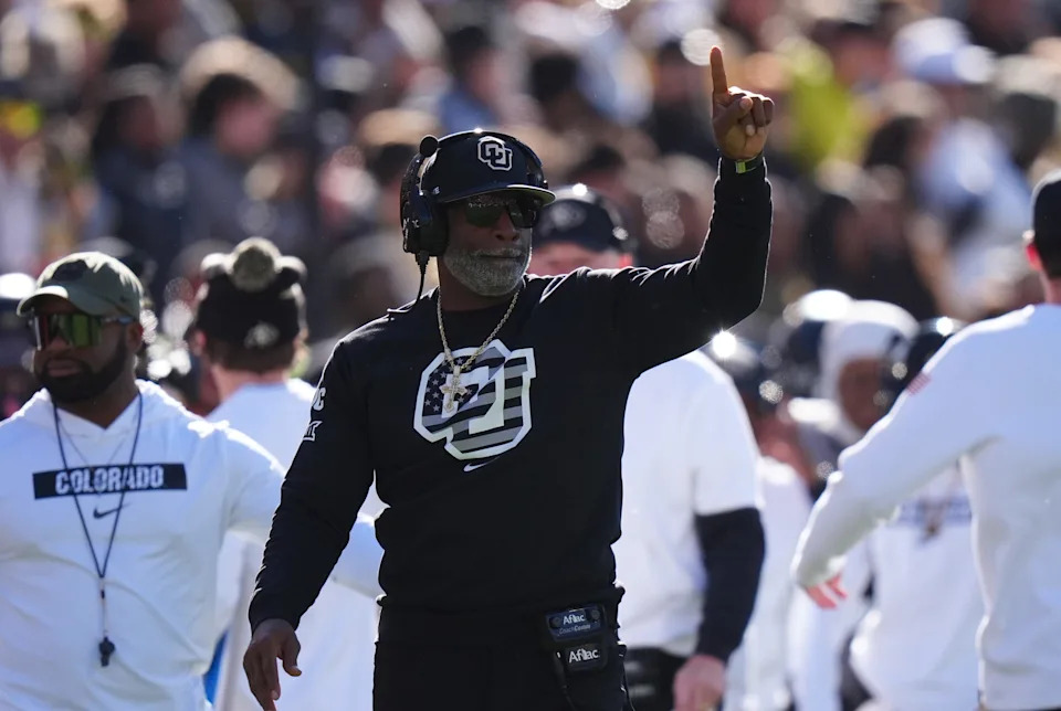 Nov 16, 2024; Boulder, Colorado, USA; Colorado Buffaloes head coach Deion Sanders calls in a play in the first quarter against the Utah Utes at Folsom Field. Mandatory Credit: Ron Chenoy-Imagn Images