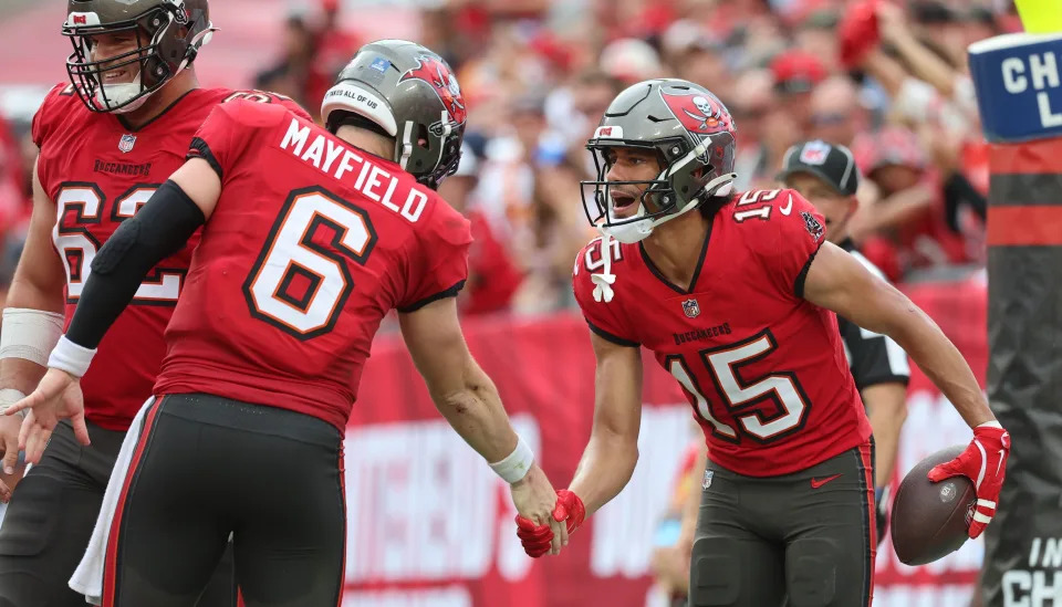 Dec 29, 2024; Tampa, Florida, USA; Tampa Bay Buccaneers wide receiver Jalen McMillan (15) is congratulated by quarterback Baker Mayfield (6) after he scored a touchdown against the Carolina Panthers during the second quarter at Raymond James Stadium. Mandatory Credit: Kim Klement Neitzel-Imagn Images