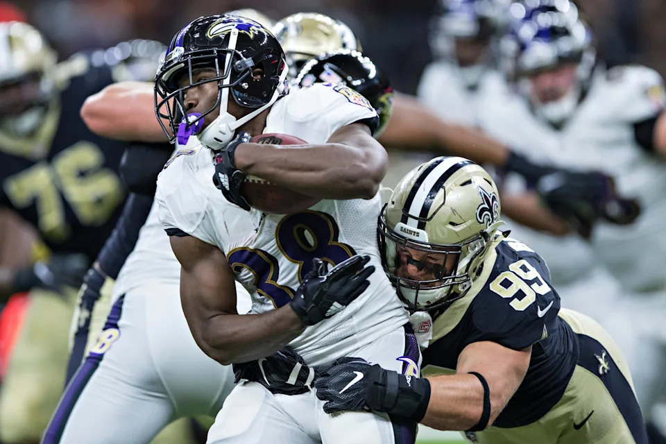NEW ORLEANS, LA - AUGUST 31: Bobby Rainey #38 of the Baltimore Ravens runs the ball and is tackled by Adam Bighill #99 of the New Orleans Saints during a preseason game at Mercedes-Benz Superdome on August 31, 2017 in New Orleans, Louisiana. The Ravens defeated the Saints 14-13. (Photo by Wesley Hitt/Getty Images)