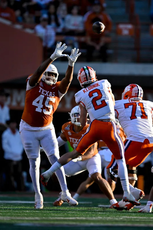 Clemson Tigers quarterback Cade Klubnik (2) is pressured by Texas Longhorns defensive lineman Vernon Broughton (45). Mandatory Credit: Jerome Miron-Imagn Images