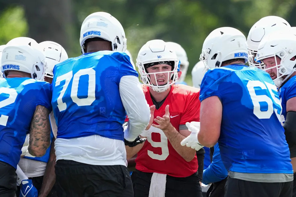 Memphis’ Seth Henigan (9) tells the offense the play they’ll be running during practice at the Billy J. Murphy Athletic Complex at the University of Memphis on Wednesday, July 31, 2024.