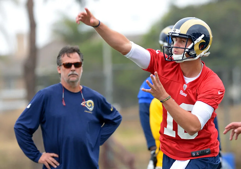 Los Angeles Rams head coach Jeff Fisher watches rookie quarterback Jared Goff (16) make a pass during minicamp workouts at River Ridge Fields.