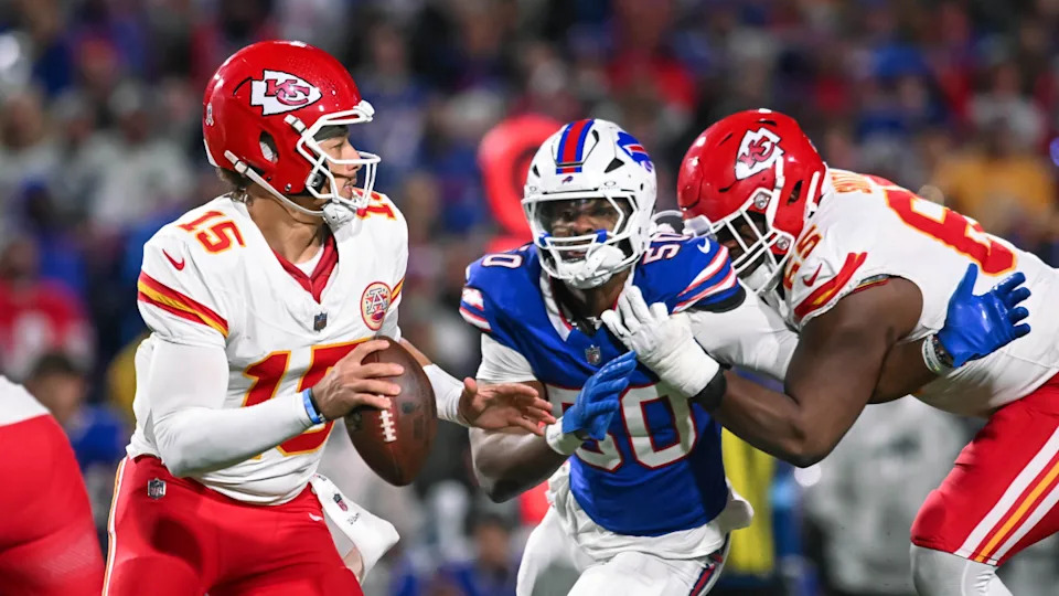 Kansas City Chiefs guard Trey Smith (65) blocks Buffalo Bills defensive end Greg Rousseau (50) in pursuit of quarterback Patrick Mahomes (15). Mark Konezny-Imagn Images