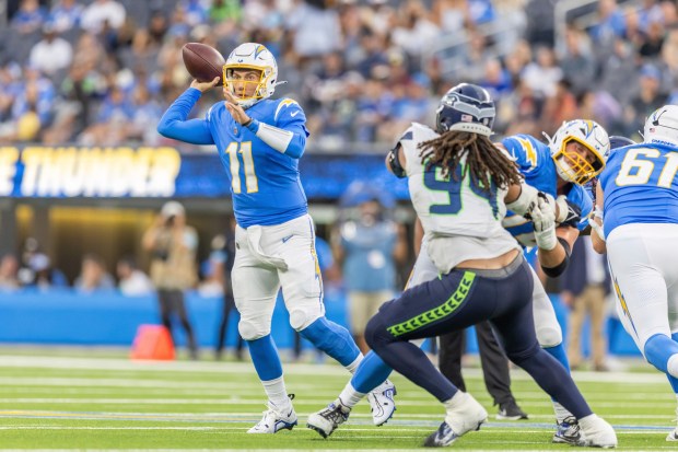 Los Angeles Chargers quarterback Luis Perez (11) passes the ball against the Seattle Seahawks in an NFL preseason football game, Saturday, Aug.10, 2024, in Inglewood, Calif. (AP Photo/Jeff Lewis)