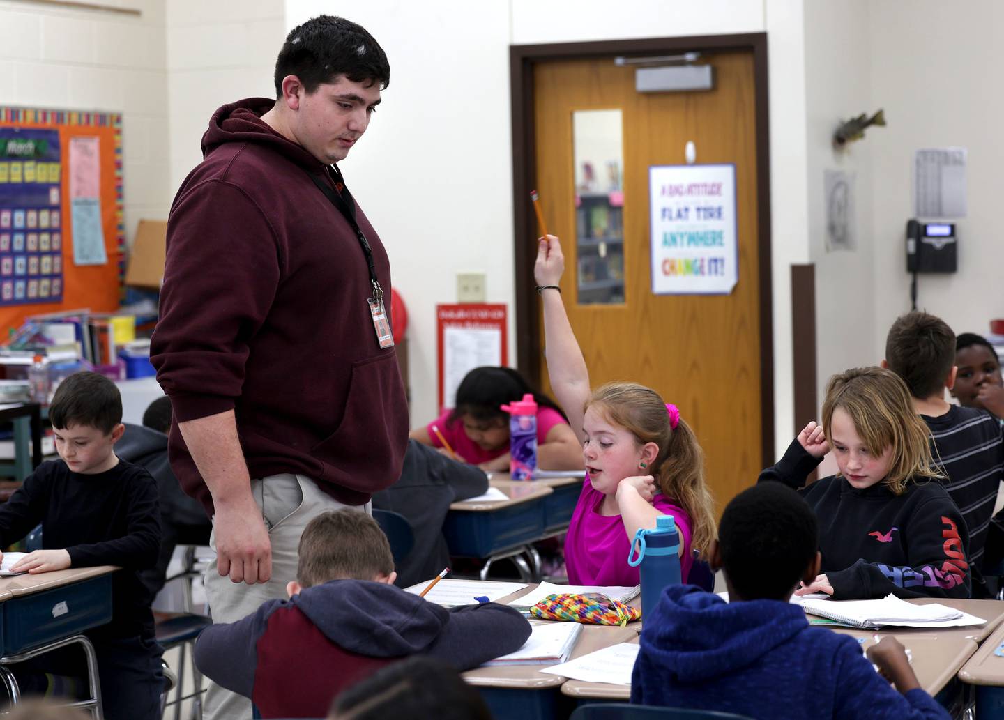 Drew Hoth, former Northern Illinois University football player and current student teacher in District 428, checks in with a student Thursday, March 20, 2025, at Jefferson Elementary School in DeKalb.