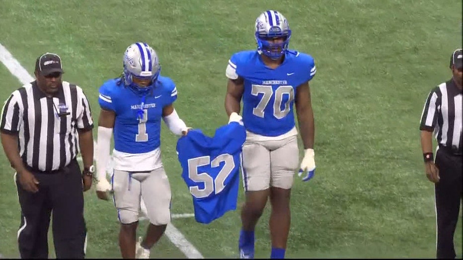 Teammates from Manchester High School honor 17-year-old defensive line Brandon Smith, whose body was found the day prior to the state championship game, at Mercedes-Benz Stadium in Atlanta on Dec. 11, 2023.