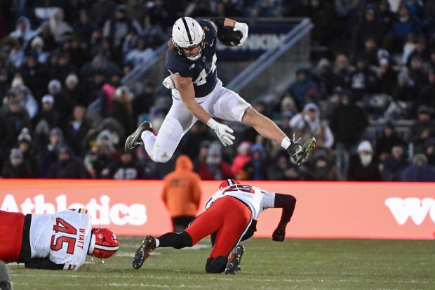 Penn State tight end Tyler Warren hurdles Maryland defensive back Kevis Thomas during the second quarter on Nov. 30, 2024, in State College, Pa. (AP Photo/Barry Reeger)
