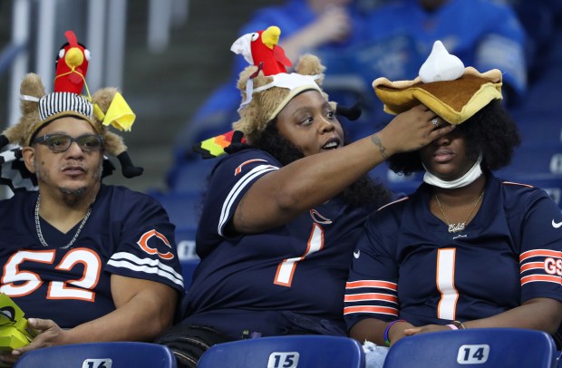 A Bears fan adjusts a fellow fan's pumpkin pie hat before a Thanksgiving game against the Lions at Ford Field on Nov. 25, 2021, in Detroit. (John J. Kim/Chicago Tribune)