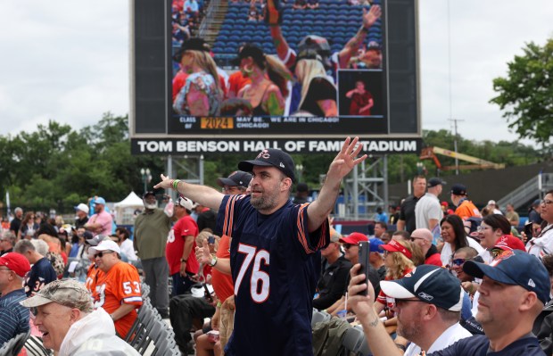 A Bears fan wearing a Steve McMichael jersey celebrates during...