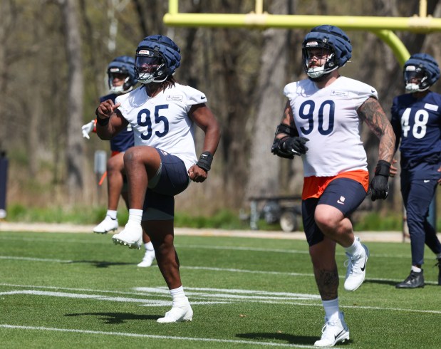 Rookie defensive linemen Shemar Turner (95) and Giovanni Paez (90) warm up during Chicago Bears rookie camp at Halas Hall on May 9, 2025, in Lake Forest. (Stacey Wescott/Chicago Tribune)