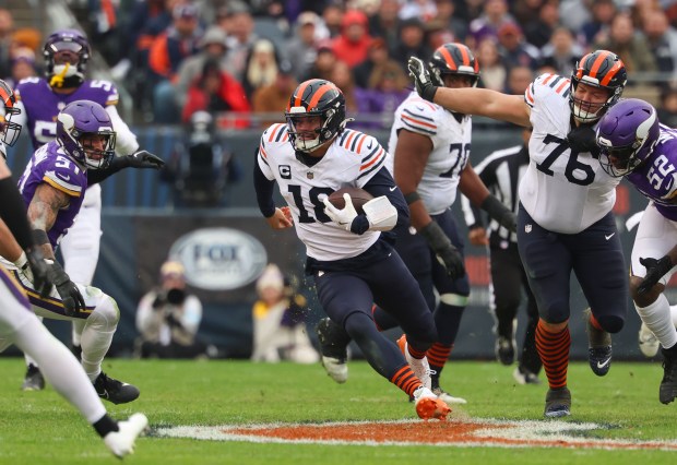 Bears quarterback Caleb Williams runs for a first down in the fourth quarter against the Vikings on Nov. 24, 2024, at Soldier Field. (Stacey Wescott/Chicago Tribune)