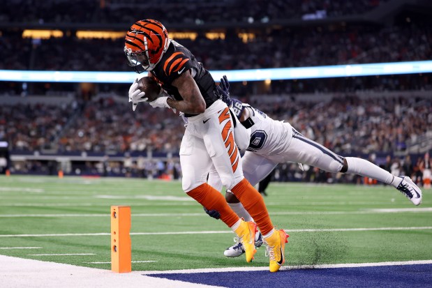 Ja'Marr Chase of the Bengals scores a touchdown against DaRon Bland of the Cowboys on Dec. 9, 2024, in Arlington, Texas. (Sam Hodde/Getty Images)