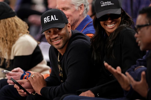 Giants quarterback Russell Wilson, left, with his wife, Ciara, talks to Chris Rock during a Clippers-Knicks game March 26, 2025, in New York. (AP Photo/Adam Hunger)