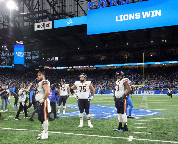 Bears offensive linemen stand on the field after losing 23-20 to the Lions on Nov. 28, 2024, at Ford Field in Detroit. (John J. Kim/Chicago Tribune)