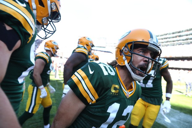 Packers quarterback Aaron Rodgers celebrates with his teammates after scoring a rushing touchdown in the fourth quarter against the Bears on Oct. 17, 2021, at Soldier Field. (Chris Sweda/Chicago Tribune)