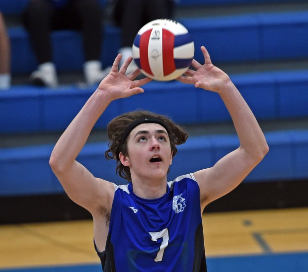 Former Wheaton St. Francis volleyball player Kyle Zediker sets the ball against Naperville Central on April 6, 2022, in Wheaton. (Jon Langham/For the Naperville Sun)