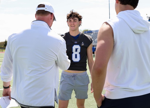 St. Charles North player Aiden McClure introduces himself to a college coach during the team's showcase day on May 7, 2025, in St. Charles. (John J. Kim/Chicago Tribune)