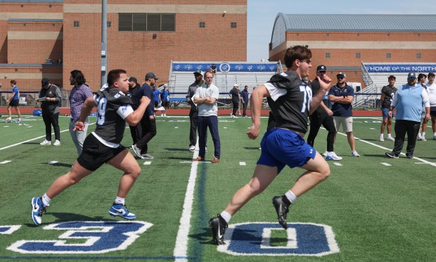 College coaches watch St. Charles North players run sprints during the team's showcase day May 7, 2025, in St. Charles. (John J. Kim/Chicago Tribune)