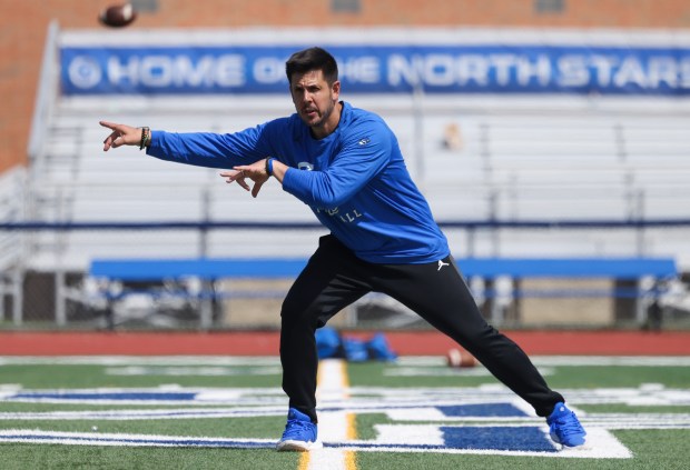 St. Charles North football coach Rob Pomazak leads a running drill during the team's showcase day May 7, 2025, in St. Charles. (John J. Kim/Chicago Tribune)