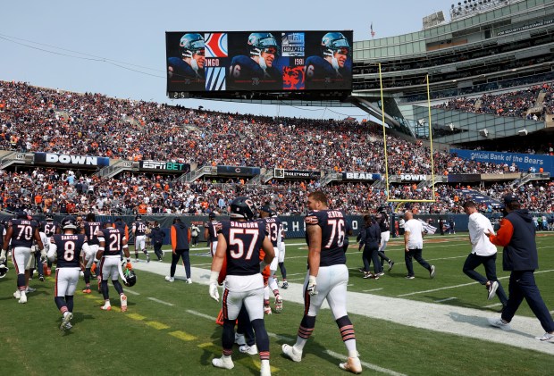 The big screen shows images of Chicago Bears great Steve...