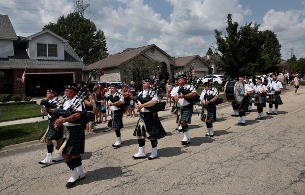 Drummers and bagpipe players from the Emerald Society of the...